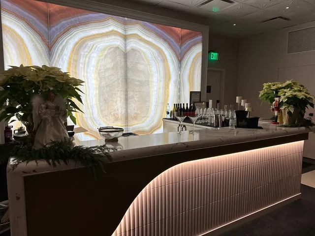 The banquet bar lit against its backlit onyx wall