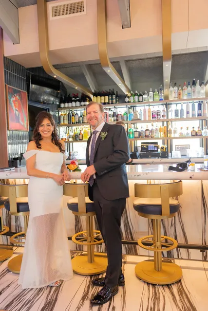 A couple at the marble bar on their wedding day
