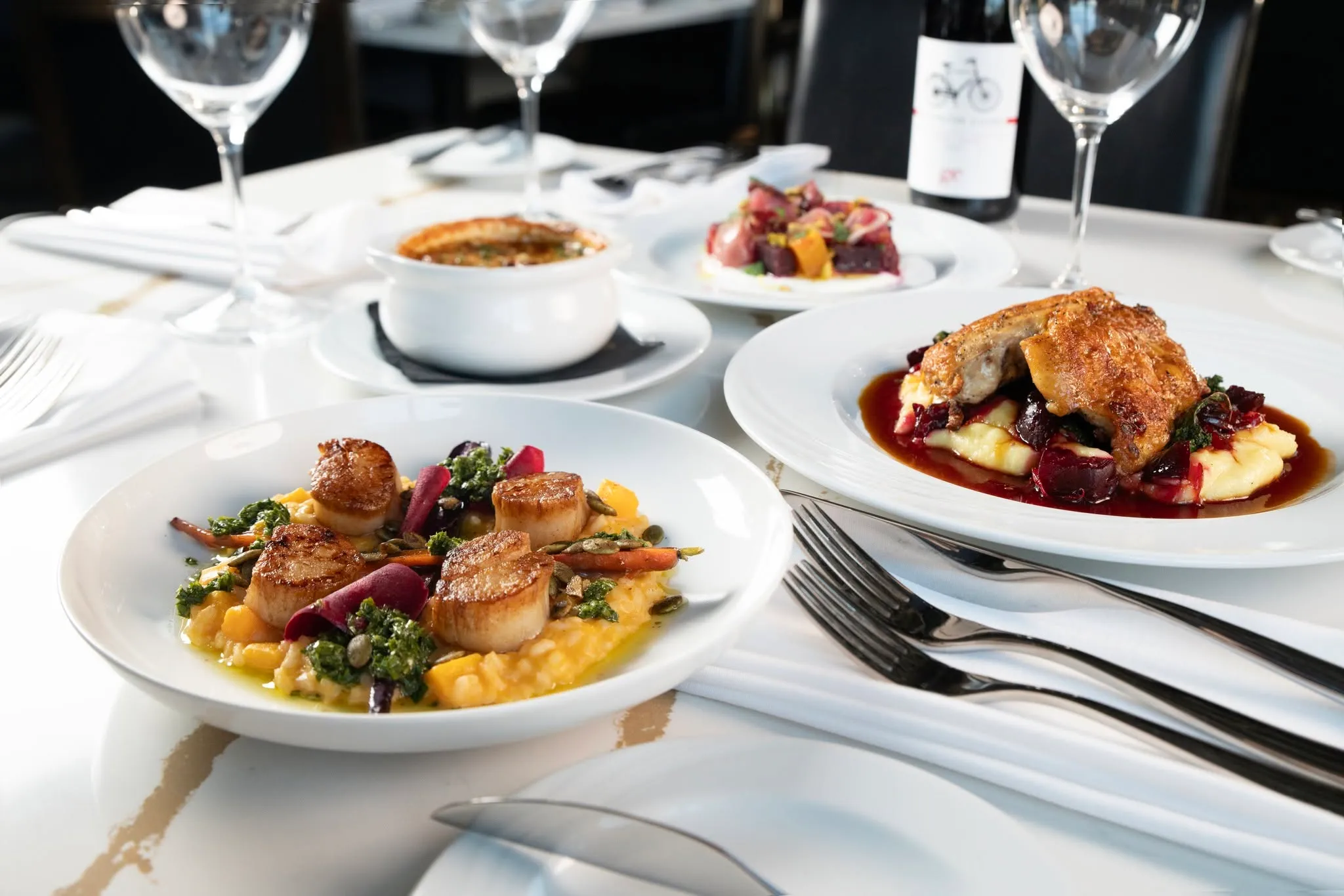 Plated courses set out on white linen