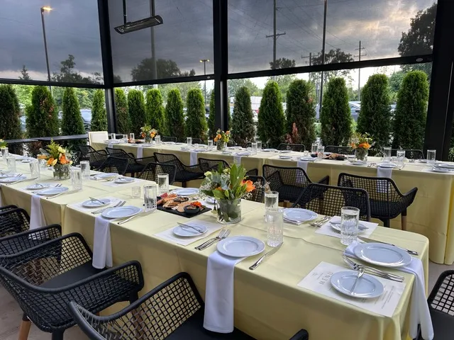 Long tables set for a party on the covered patio